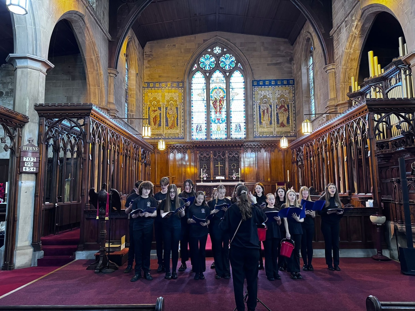 Freddie's Brass Band and the Take Note Choir performing at the Tyldesley Makers Market event at St George's Church.