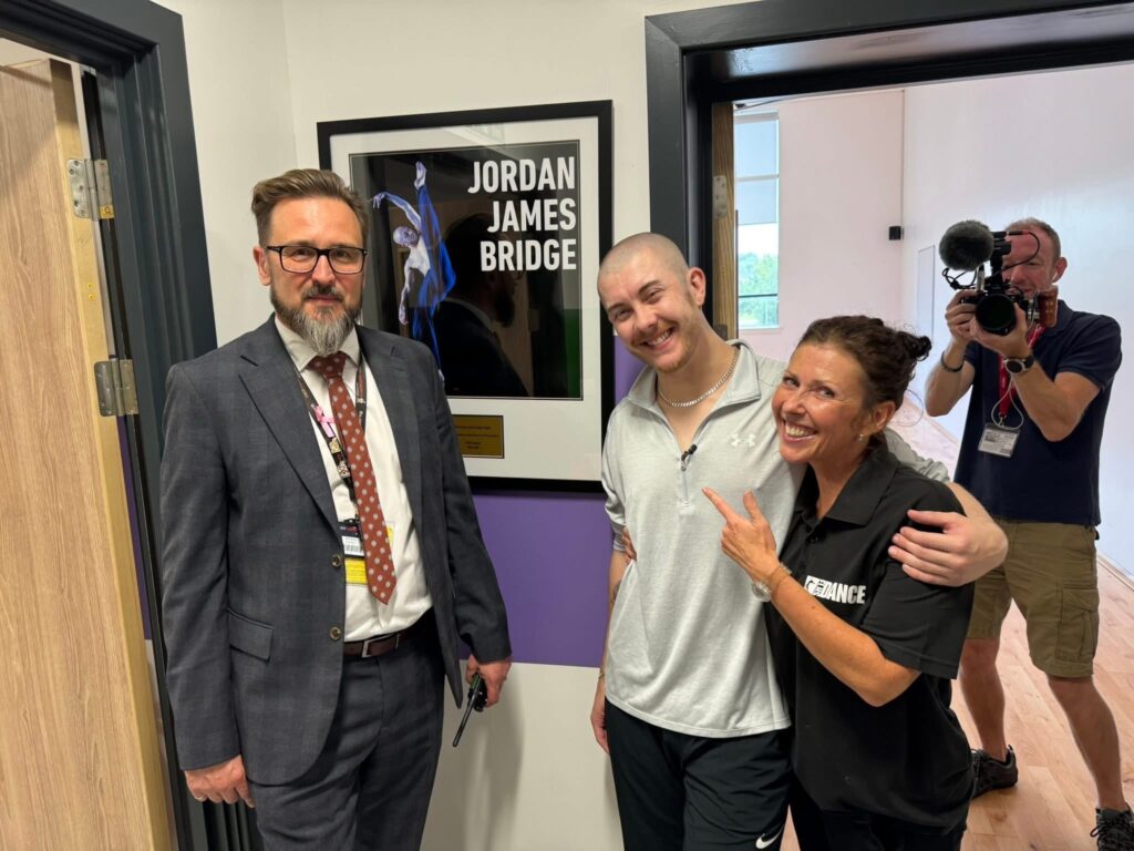 Caption: Jordan James Bridge visits Fred Longworth High School, to officially open the Dance Studio which was named in his honour. Jordan is pictured with Mr Paul Davies (Headteacher) and Mrs Keeley McPhail (Head of Dance and Jordan’s former teacher).
